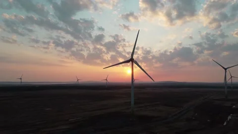 Slow Motion Shot of a Wind Farm at Sunset Stock Footage 196295905