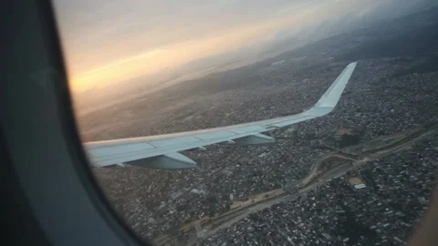 Slow motion shot from the windows of an airplane starting a fly Stock Footage 137676732