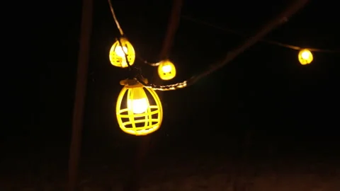 Slow motion shot of work light string swinging in snow storm Stock Footage 147387708