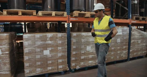 Slow motion shot of a worker inspecting boxes in a warehouse Stock Footage 65041314