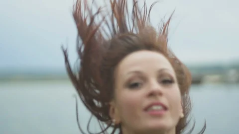Slow motion shot young beautiful brunette woman throwing her hair back. Stock Footage 116688366