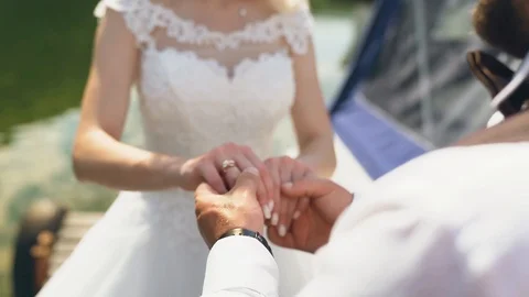 Slow motion shot of young couple holding hands and walking along the pier Stock Footage 107807096