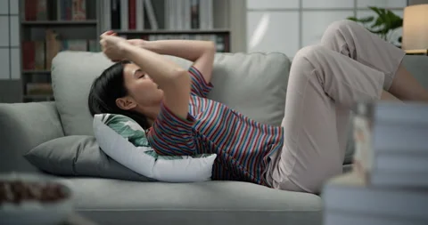 Slow motion shot, Young pretty woman to resting, she come in and lying 스톡 동영상 240701996