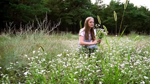 Slow motion shot of young tender florist smelling flowers bouquet sitting on Stock Footage 104418522