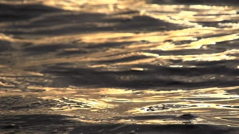 Slow motion shots of the sun's reflection in water streams.Close up Stock Footage 105292860