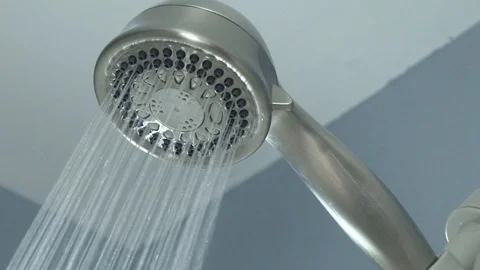 Slow motion of shower head turning on Video stock 121551032