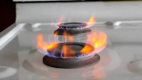 Slow motion shows flame tips of natural gas stovetop burners Video stock 120584075