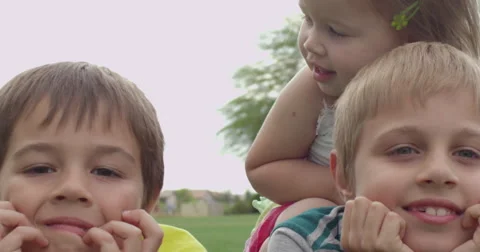 Slow Motion Siblings Playing on the Grass in a Park Stock Footage 61521911