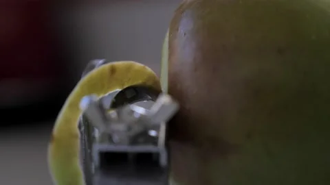 Slow motion side perspective metal kitchen device peeling, cutting and Stock Footage 139181613
