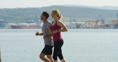 Slow Motion Side Shot Of Couple Training For Marathon Stock Footage 123851024