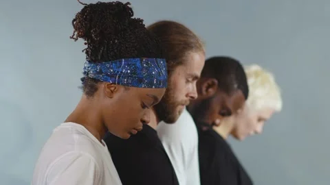 Slow motion side shot of group of people of different races raise head black Stock Footage 133641295