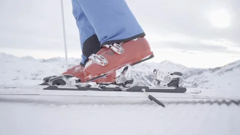 Slow motion side view detail step in ski binding Stock Footage 100110020