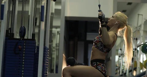 Slow motion, side view footage of a young blonde lady with ponytail seated on a Stock Footage 123065792