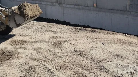 Slow Motion Side View of Heavy Loader Moving Earth Vídeo Stock 332595398