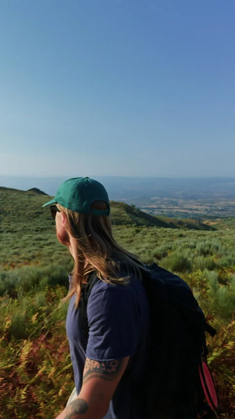 Slow Motion Side View of Hiker on Green Hills Stock-Footage 345529207