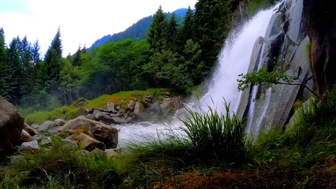 Slow motion side view of a waterfall in the mountain forest	 Stock Footage 149321920
