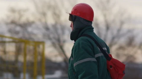 Slow Motion Side View Worker Walks along Winter Oil Field 스톡 동영상 79208583