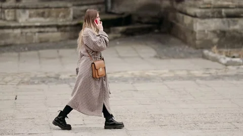 Slow motion side view of a Young beautiful blonde woman in stylish clothes Stock Footage 151858275