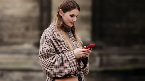 Slow motion side view of a Young beautiful blonde woman in stylish clothes Stock Footage 151899241