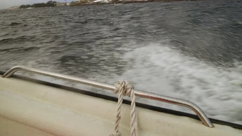 Slow motion sideview of a small boat cutting through the sea creating waves Stock Footage 203894708