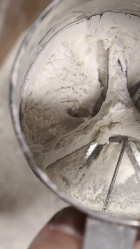 Slow motion of sifting flour with a sieve Video stock 344985704