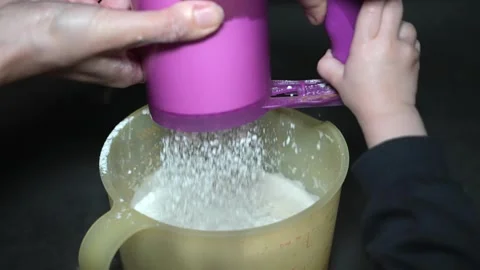 Slow Motion Sifting Flour Together with Child While Baking Video stock 320393609
