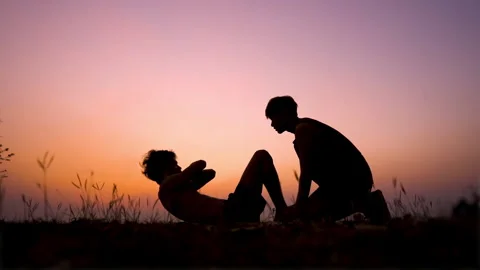 Slow motion, Silhouette, black shadow of slim male doing sit ups exercises . Stock Footage 152570451