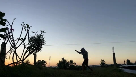 Slow Motion Silhouette of Boxer Shadow Boxing Outdoors at Sunset Stock Footage 337916554