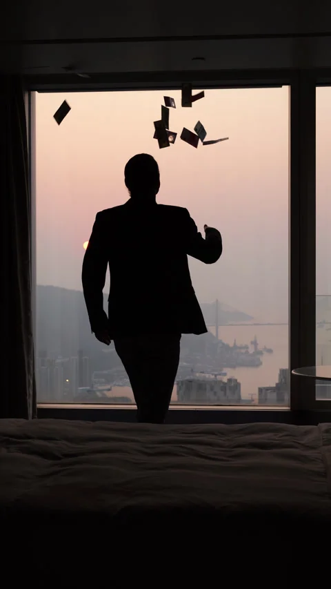 Slow motion silhouette of businessman throwing banknotes in air by window Stock Footage 341004577