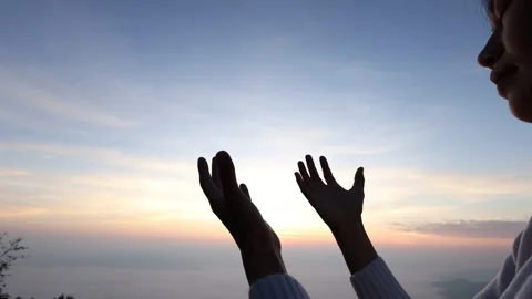 Slow motion silhouette of Human hands open palm up worship. Eucharist Thera.. Stock Footage 336934942