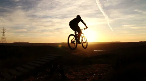 Slow Motion Silhouette Man Mountain Biking Off Extreme Jump Stock Footage