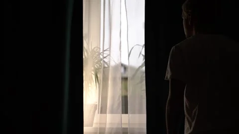 Slow motion silhouette Man opens the curtains in the morning Video stock 132723918