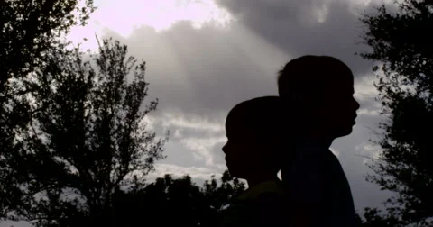 Slow Motion Silhouette of Two Boys in a Park Stock Footage 61652083