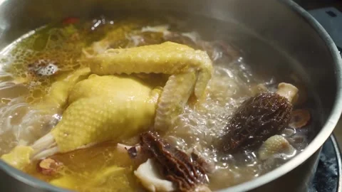 Slow Motion Simmering Chicken Broth with Morel Mushrooms in Pot Stock Footage 341926320