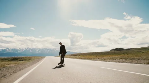Slow Motion Skateboarder Riding Down Hill At Sunset Stock Footage 65485618
