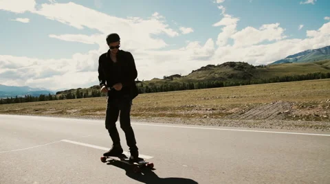 Slow Motion Skateboarder Riding Down Hill At Sunset Stock Footage 65485727