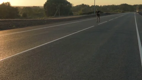 Slow Motion Skateboarder Riding Down Hill At Sunset Stock Footage 79398202