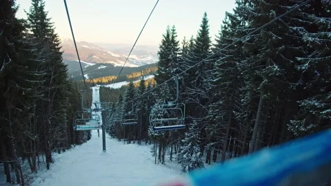 Slow motion of ski elevator working at skiing resort. Pov person travel by chair Stock Footage 148975547