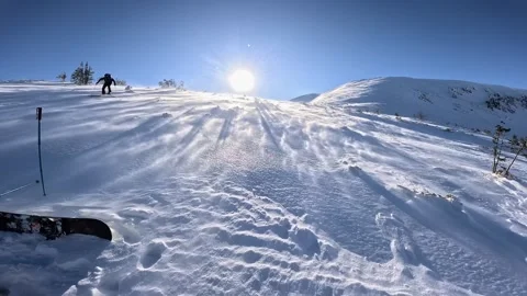 Slow motion ski touring uphill on a windy, snowy backcountry slope, sunlit snow Stock Footage 321751230