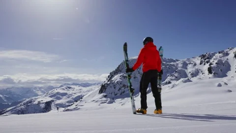 Slow motion of skier looking at mountains Stock Footage 248073450