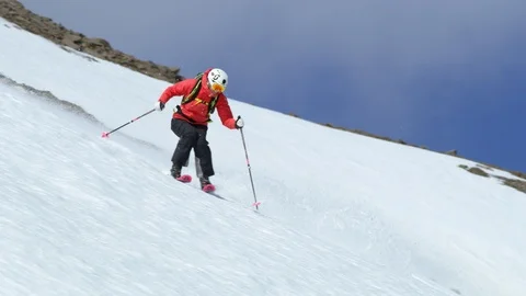 Slow Motion of skier in red jacket freeriding in Iceland Stock Footage 124228511