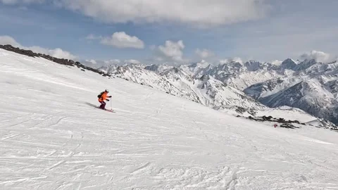Slow motion skiing through snowy mountain landscape on sunny day Video stock 281791695