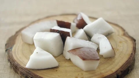 Slow motion of slice of fresh coconut falling on a table Stock Footage 280094300
