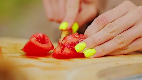 Slow Motion Slice of Tomato with Bio Knife on Rustic Wooden Cutting Board Stock Footage 313985154
