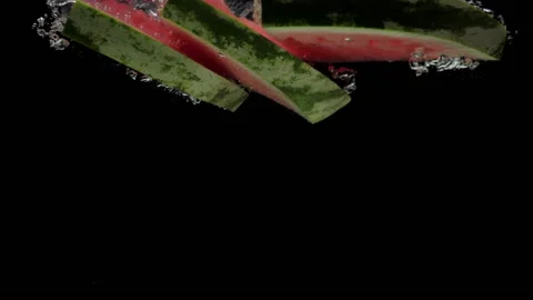 Slow motion slice watermelon falling into transparent water on black background Stock Footage 197073604