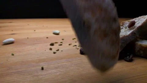 Slow motion of sliced bread falling on table and hand grabbing it Stock Footage 131116374