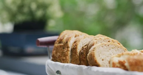 Slow motion sliced breads on breakfast table with green background Stock Footage 91009994