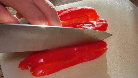 Slow Motion Slicing of Bright Red Bell Pepper Stock Footage 319776982