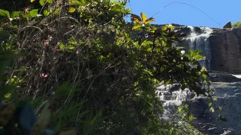 Slow Motion Slide to a Rust-Colored Multi-Level Waterfall Stock Photos