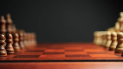 Slow Motion Slider Pan Across Chessboard Pieces on Opposite Sides Stock Footage 236946310